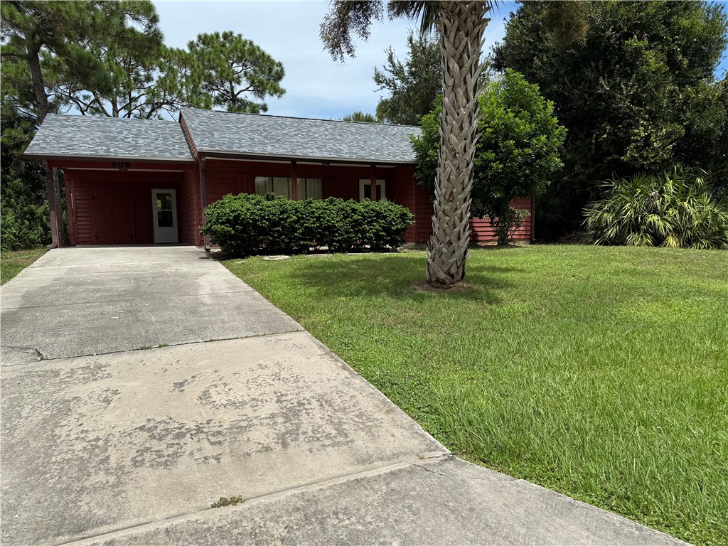 608 Stevenson Avenue Sebastian, FL 32958 - Photo 3 of 22 a front view of a house with a garden