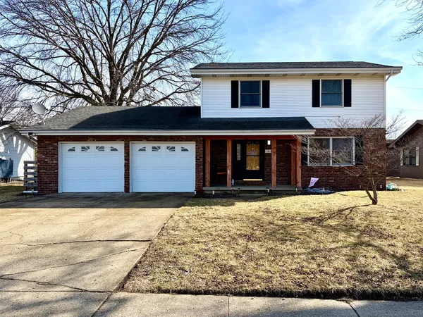 a house that has a tree in front of it