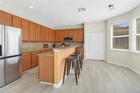 a kitchen with a refrigerator a stove top oven a sink and a refrigerator