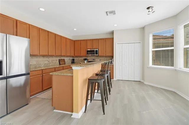 a kitchen with a refrigerator a stove top oven a sink and a refrigerator