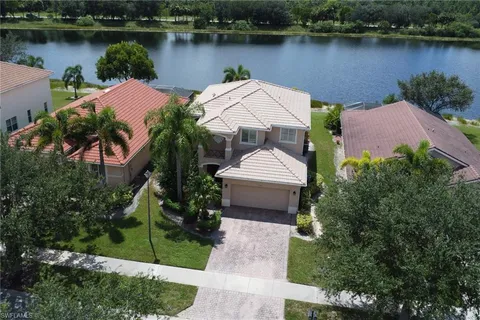 an aerial view of a house with garden space and a lake view