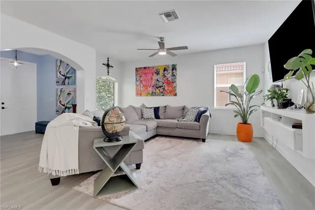 a living room with furniture and a flat screen tv