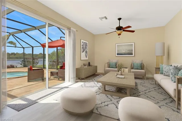 a living room with furniture a ceiling fan and a table