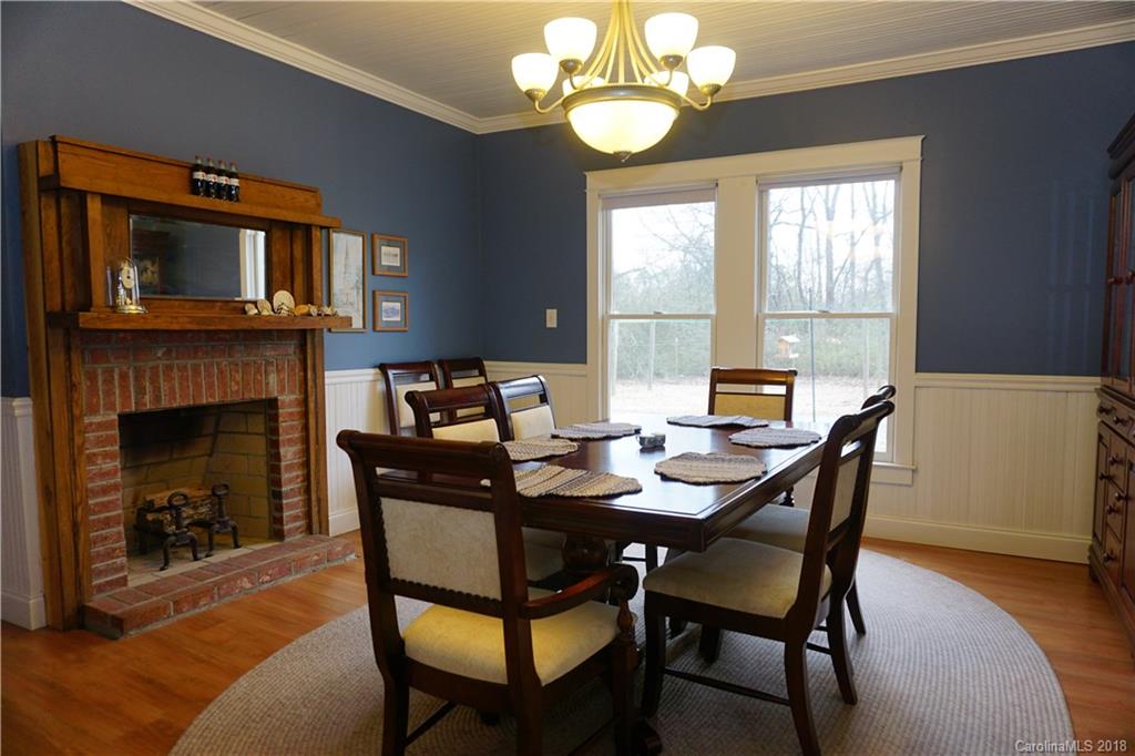 2425 Chesnee Road Columbus, NC 28722 - Photo 12 of 35 a view of a dining room with furniture a fireplace and wooden floor