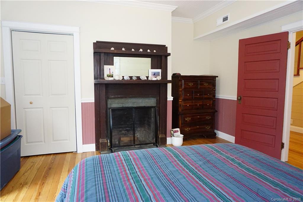 2425 Chesnee Road Columbus, NC 28722 - Photo 13 of 35 a living room with a fireplace and wooden floor