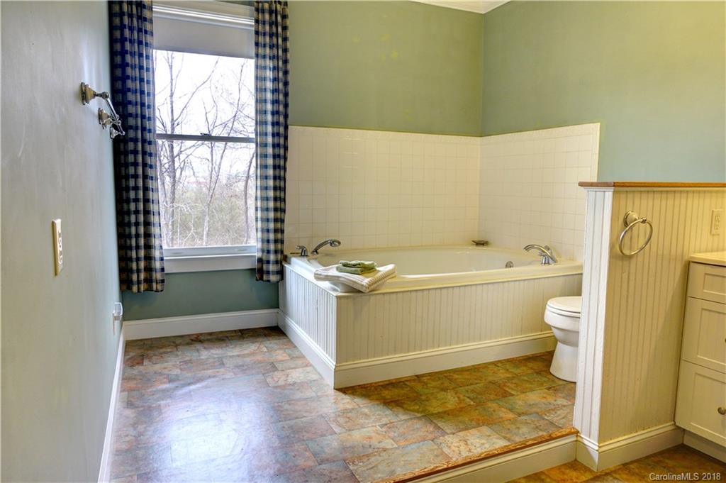 2425 Chesnee Road Columbus, NC 28722 - Photo 16 of 35 a bathroom with a bathtub and a toilet