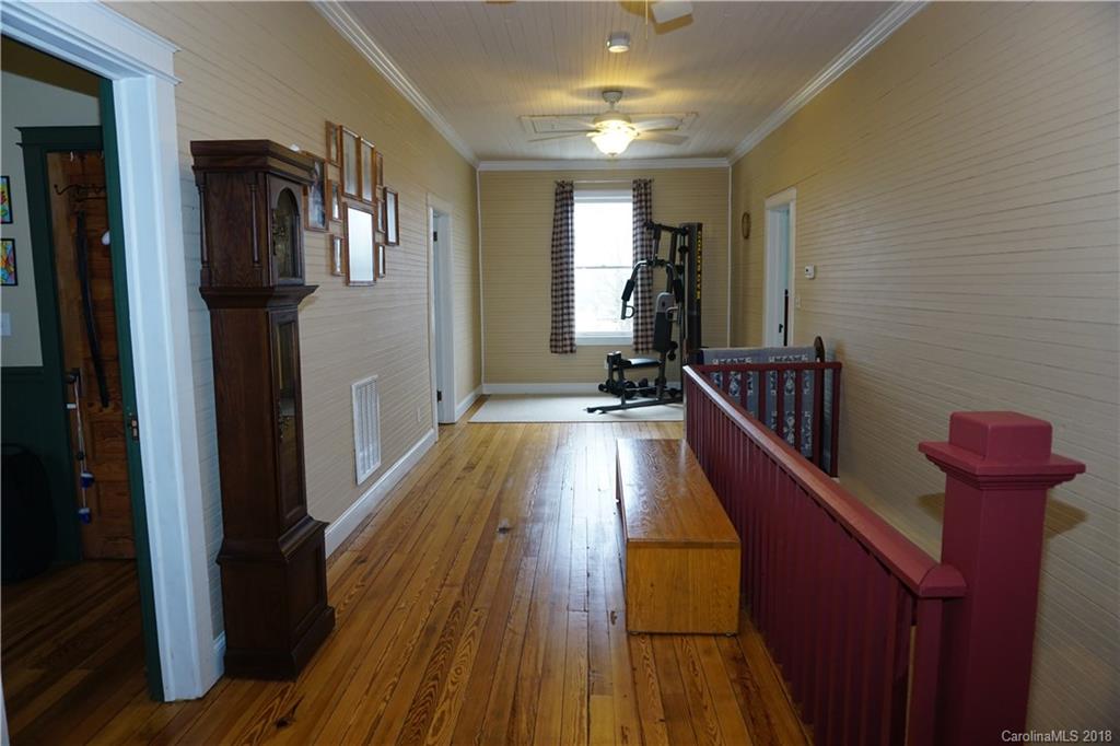2425 Chesnee Road Columbus, NC 28722 - Photo 20 of 35 a view of a hallway with wooden floor and staircase