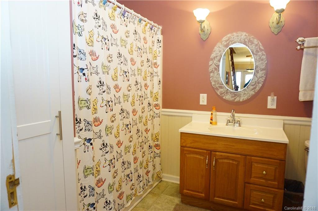 2425 Chesnee Road Columbus, NC 28722 - Photo 22 of 35 a bathroom with a double vanity sink and a mirror