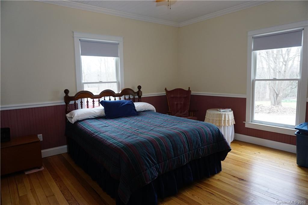 2425 Chesnee Road Columbus, NC 28722 - Photo 25 of 35 a bedroom with a bed and wooden floor