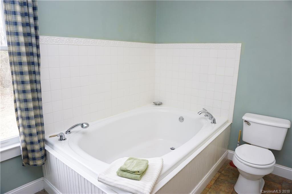 2425 Chesnee Road Columbus, NC 28722 - Photo 29 of 35 a white bath tub sitting next to a white toilet