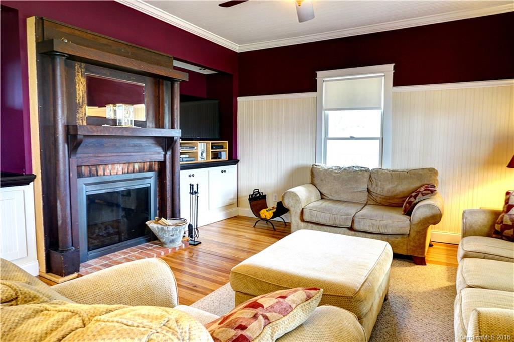 2425 Chesnee Road Columbus, NC 28722 - Photo 6 of 35 a living room with furniture a flat screen tv and a fireplace