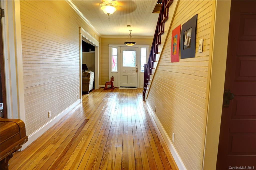 2425 Chesnee Road Columbus, NC 28722 - Photo 7 of 35 a view of a hallway with wooden floor and staircase