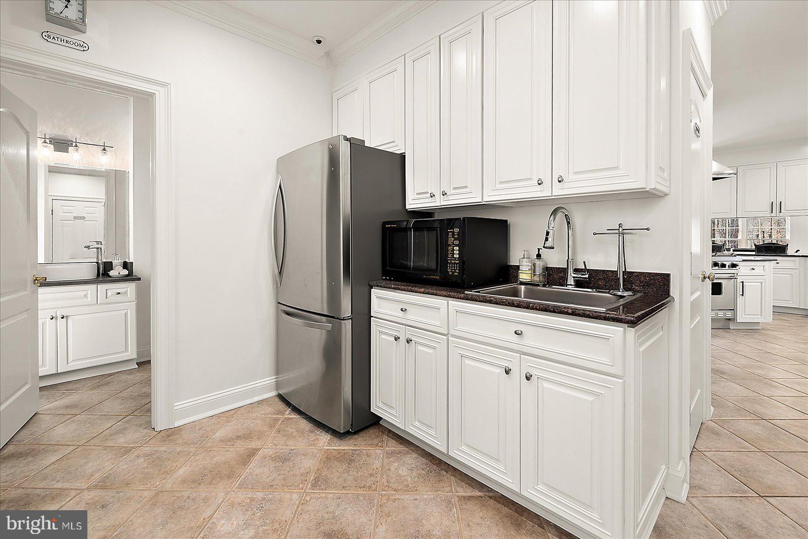 17 Perder Lane Edgewater, MD 21037 - Photo 32 of 115 a kitchen with white cabinets and refrigerator