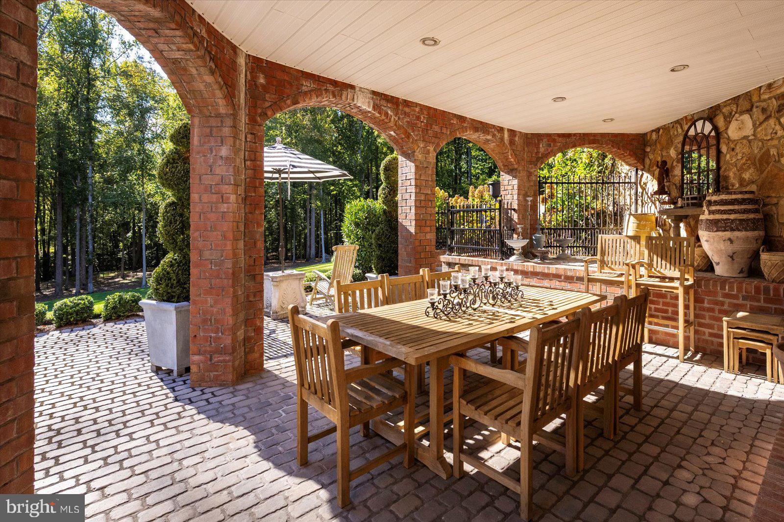 17 Perder Lane Edgewater, MD 21037 - Photo 82 of 115 a view of a patio with table and chairs with wooden floor and fence
