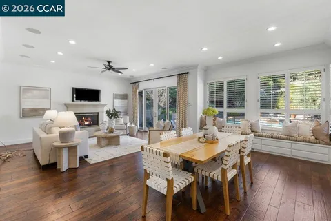 a living room with furniture a large window and a flat screen tv