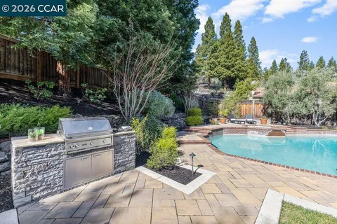 a bathroom with a granite countertop tub a sink and a large mirror