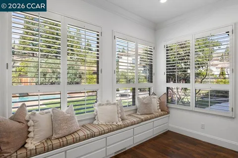 a living room with furniture and large windows