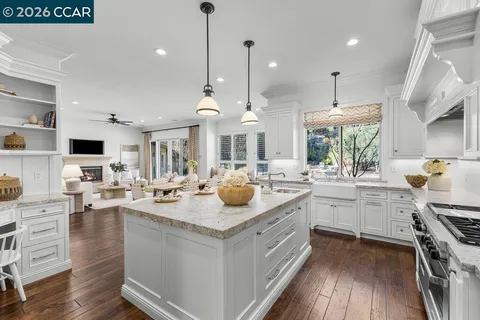 a kitchen with sink stove and cabinets