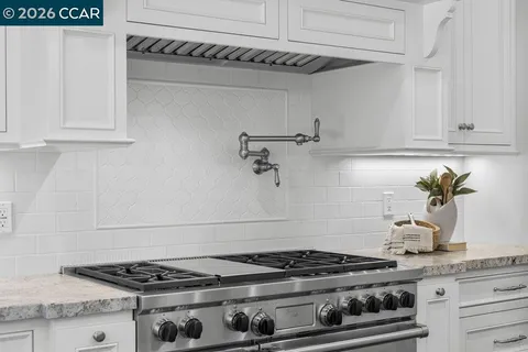 a stove top oven sitting inside of a kitchen