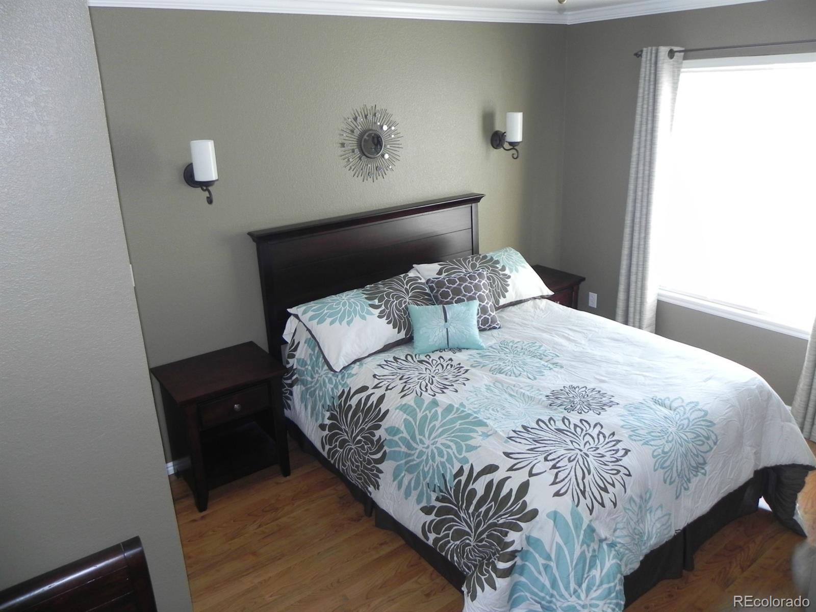 679 Timbervale Trail Highlands Ranch, CO 80129 - Photo 16 of 26 a bed sitting in a bedroom next to a window