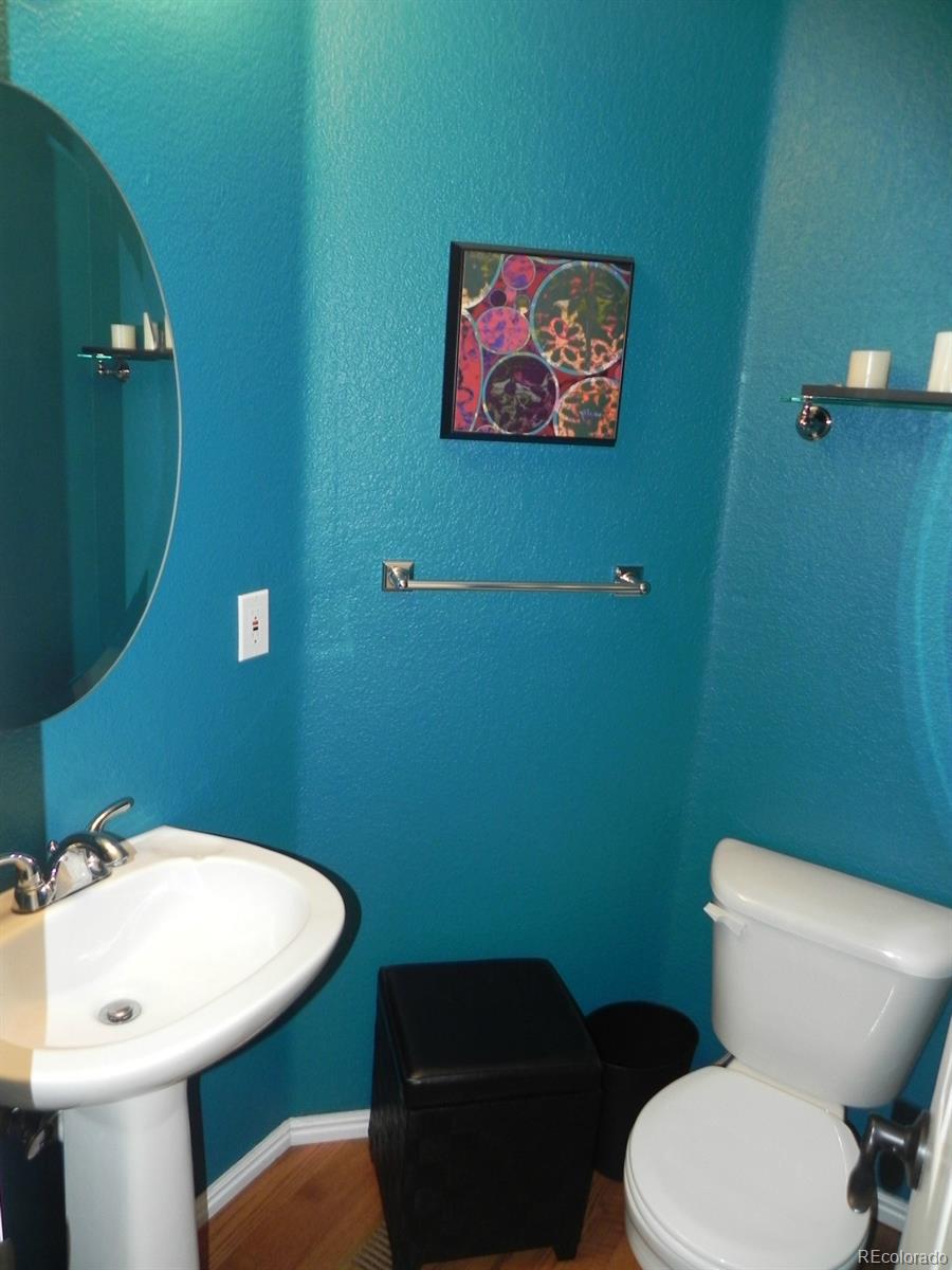 679 Timbervale Trail Highlands Ranch, CO 80129 - Photo 5 of 26 a bathroom with a toilet a sink and mirror