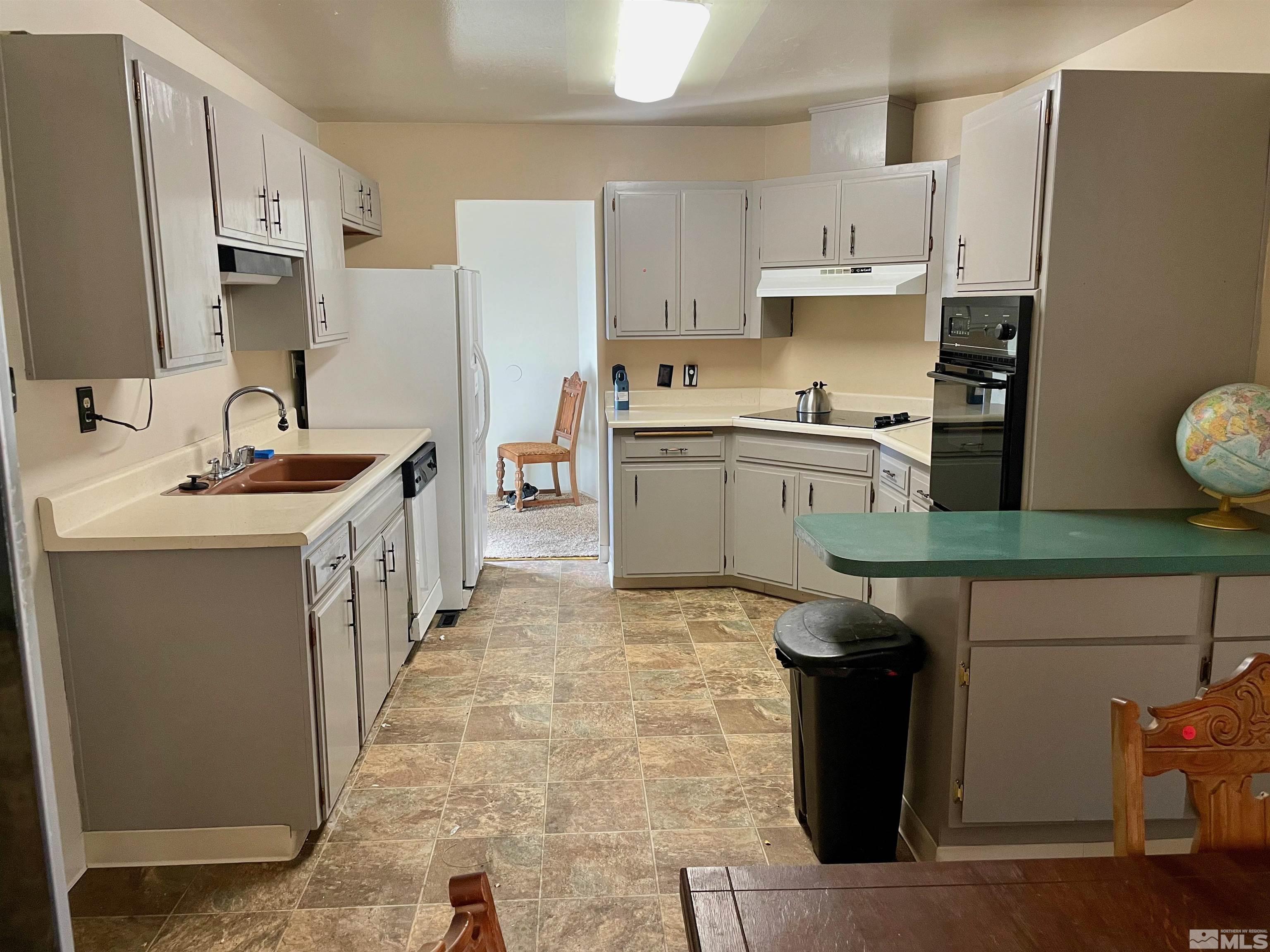 701 Wyoming Avenue Reno, NV 89503 - Photo 3 of 10 a kitchen with stainless steel appliances granite countertop a sink stove and refrigerator