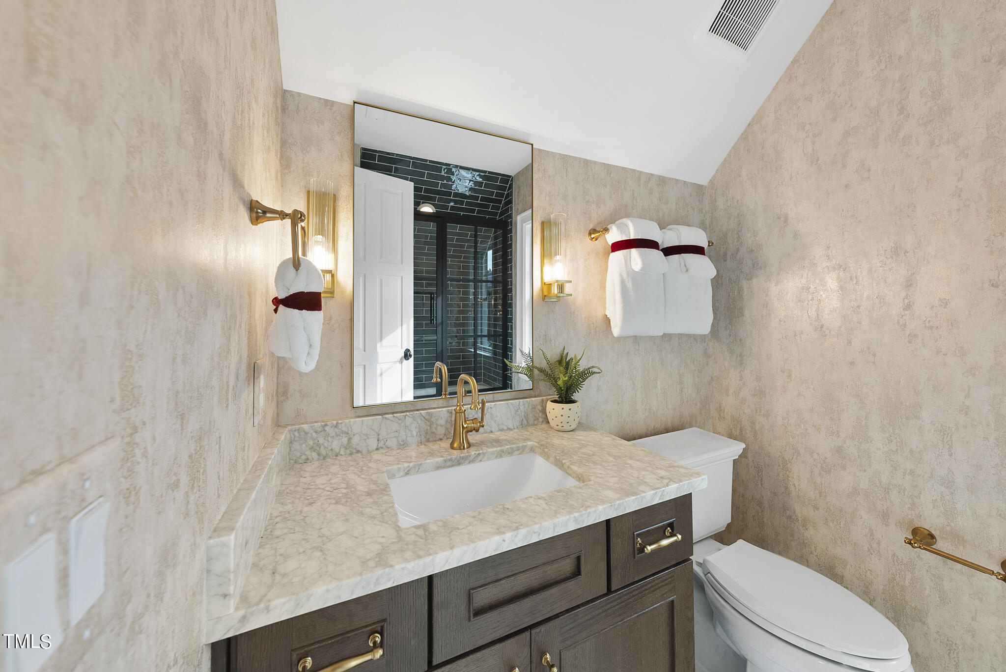 2009 St Marys Street Raleigh, NC 27608 - Photo 17 of 88 a bathroom with a granite countertop sink a toilet and mirror