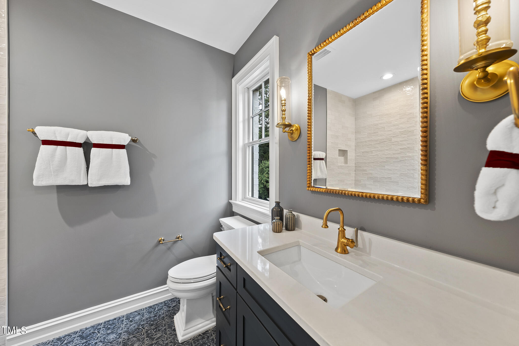 2009 St Marys Street Raleigh, NC 27608 - Photo 34 of 88 a bathroom with a sink a toilet and mirror