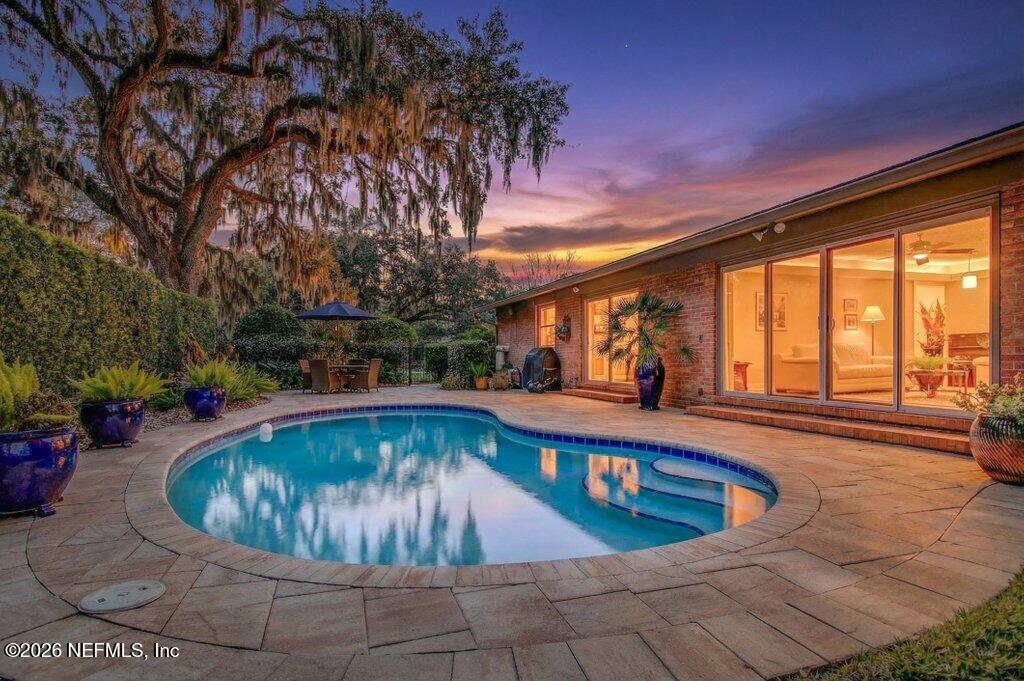 a view of a swimming pool with sitting area