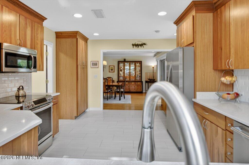 8349 Kim Road Jacksonville, FL 32217 - Photo 20 of 73 a view of kitchen with stainless steel appliances granite countertop sink stove refrigerator and cabinets