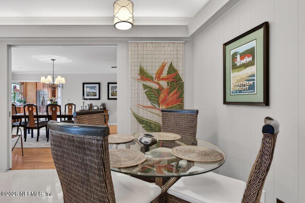8349 Kim Road Jacksonville, FL 32217 - Photo 21 of 73 a dining room with furniture and wooden floor