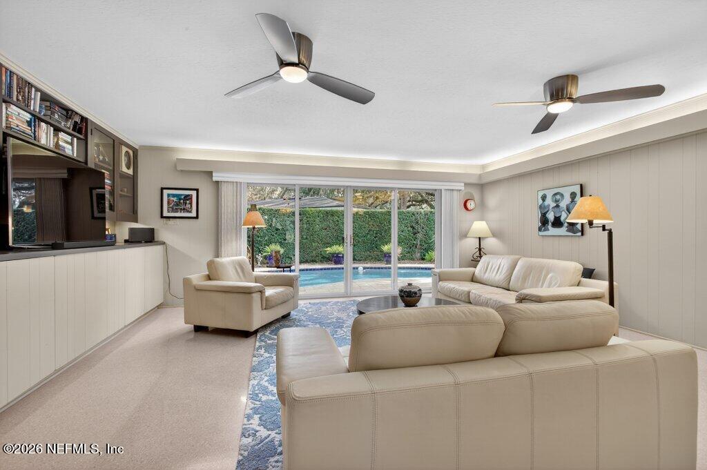 8349 Kim Road Jacksonville, FL 32217 - Photo 25 of 73 a living room with furniture and a flat screen tv