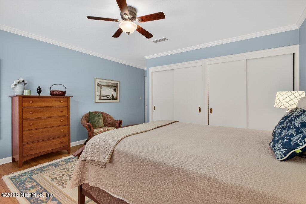 8349 Kim Road Jacksonville, FL 32217 - Photo 41 of 73 a bedroom with a bed and a chandelier