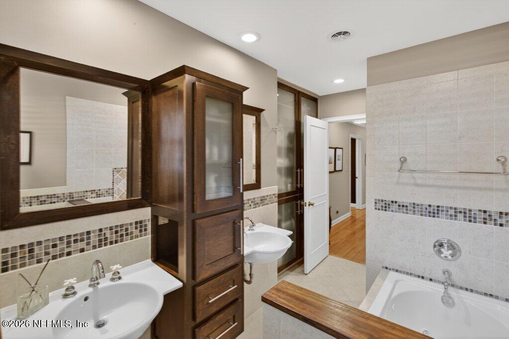 8349 Kim Road Jacksonville, FL 32217 - Photo 42 of 73 a bathroom with a sink and a mirror