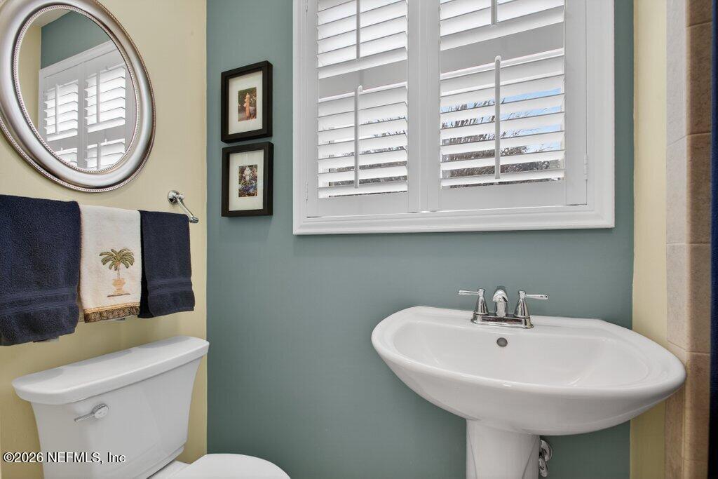 8349 Kim Road Jacksonville, FL 32217 - Photo 51 of 73 a bathroom with a toilet a sink and a mirror