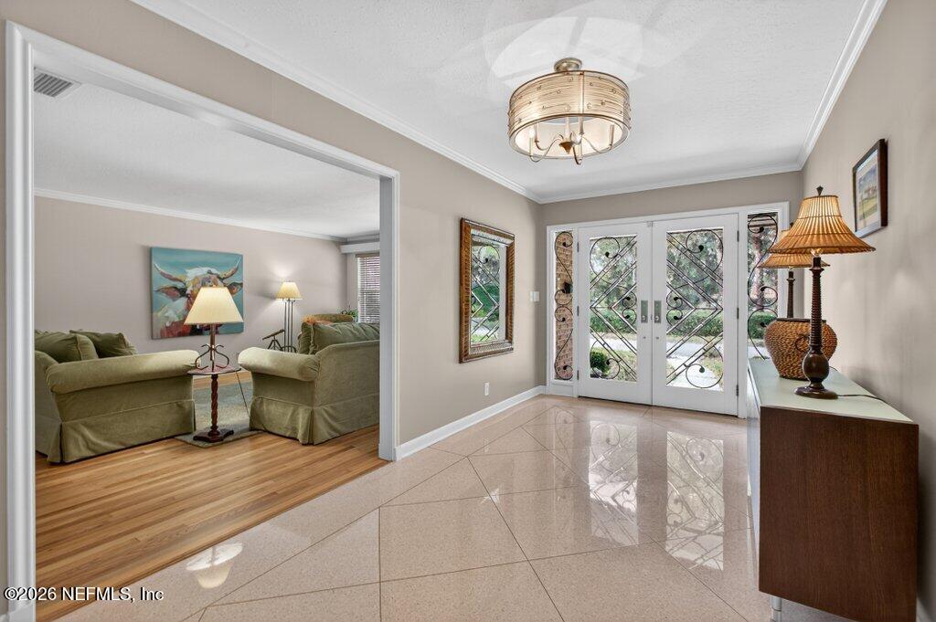 8349 Kim Road Jacksonville, FL 32217 - Photo 10 of 73 a view of living room with furniture and a chandelier