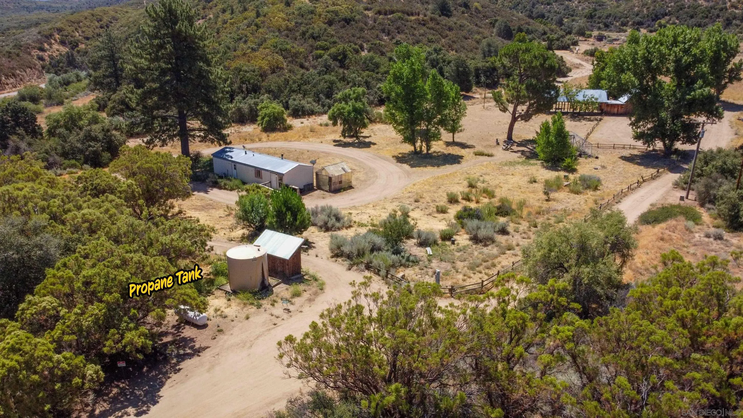 60815 Burnt Valley Road Anza, CA 92539 - Photo 9 of 40 a view of a dry yard covered with snow and trees