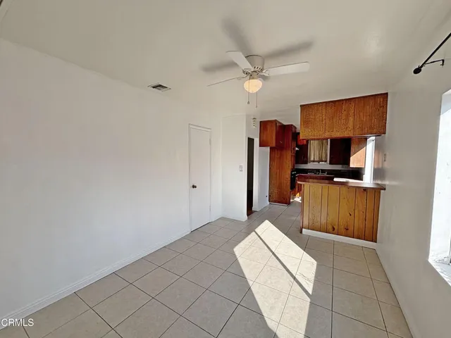 a kitchen with granite countertop a refrigerator and a stove top oven