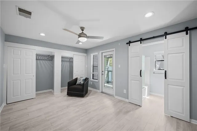 a living room with furniture and a ceiling fan