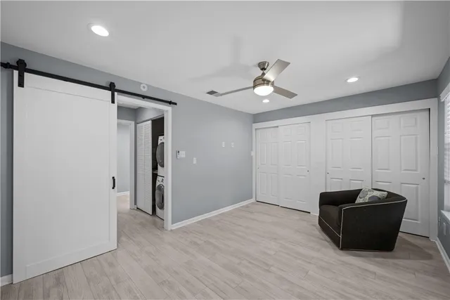 a view of a room with wooden floor and ceiling fan