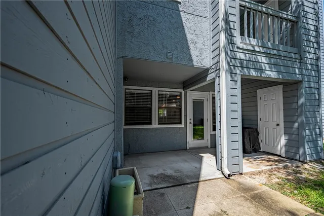 a front view of a house with a tree in front