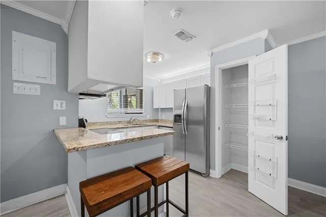 a kitchen with a table and refrigerator
