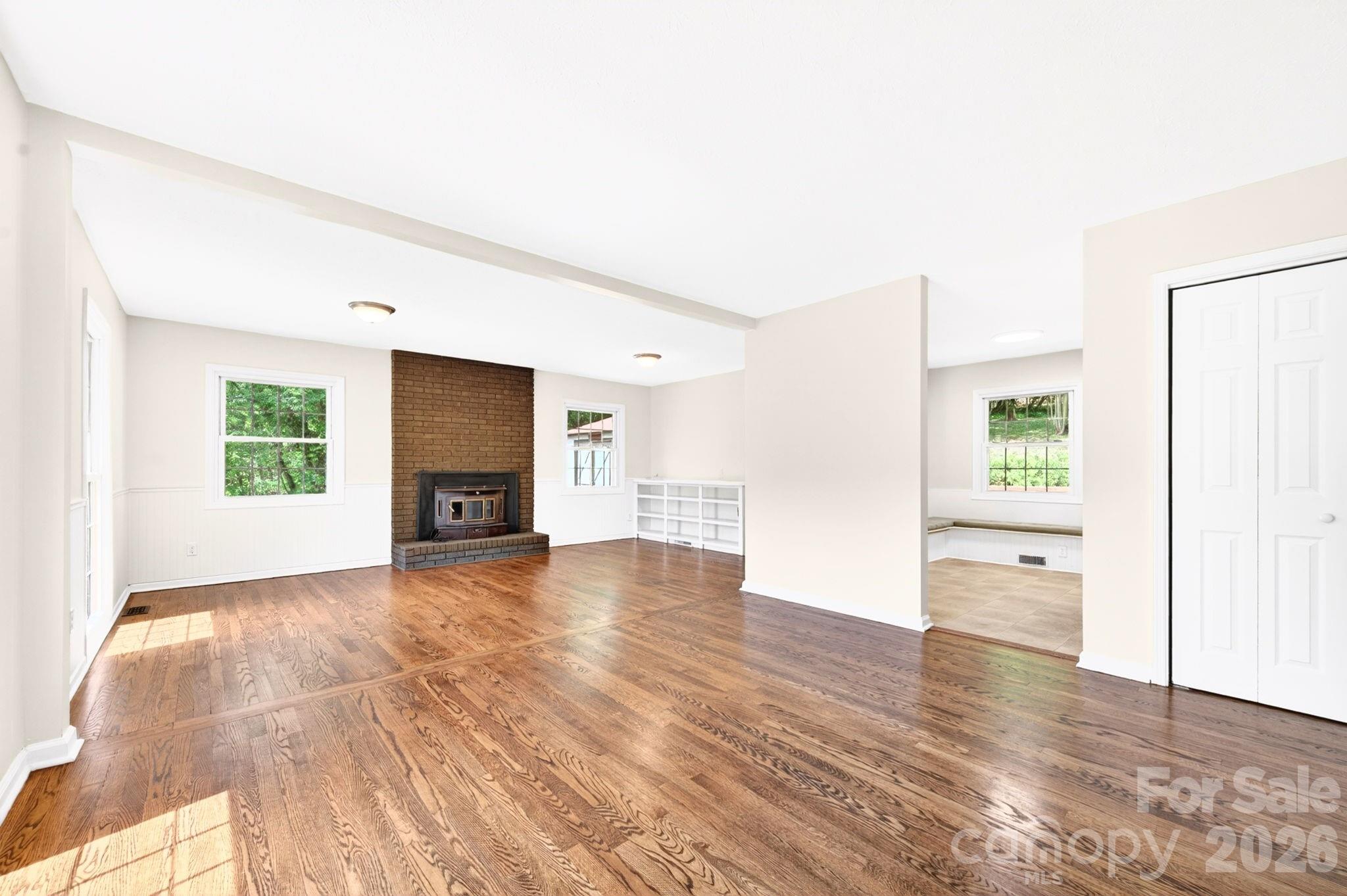 34 Wolfe Cove Road Asheville, NC 28804 - Photo 3 of 42 a view of an empty room with window and wooden floor
