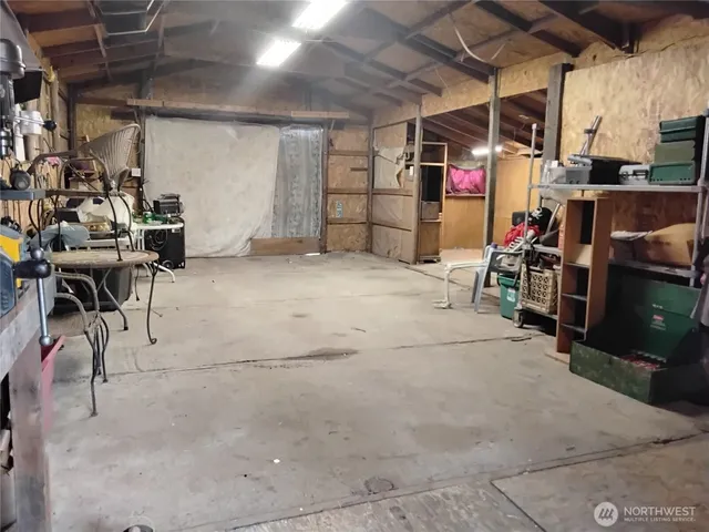 a view of a room with wooden floor and a ceiling fan