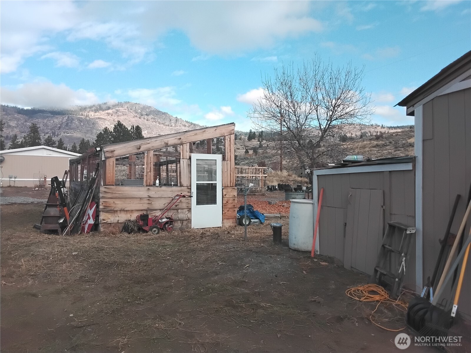 20 Round Up Road Oroville, WA 98844 - Photo 8 of 39 a view of a house with a flat tv screen and a car parked in it