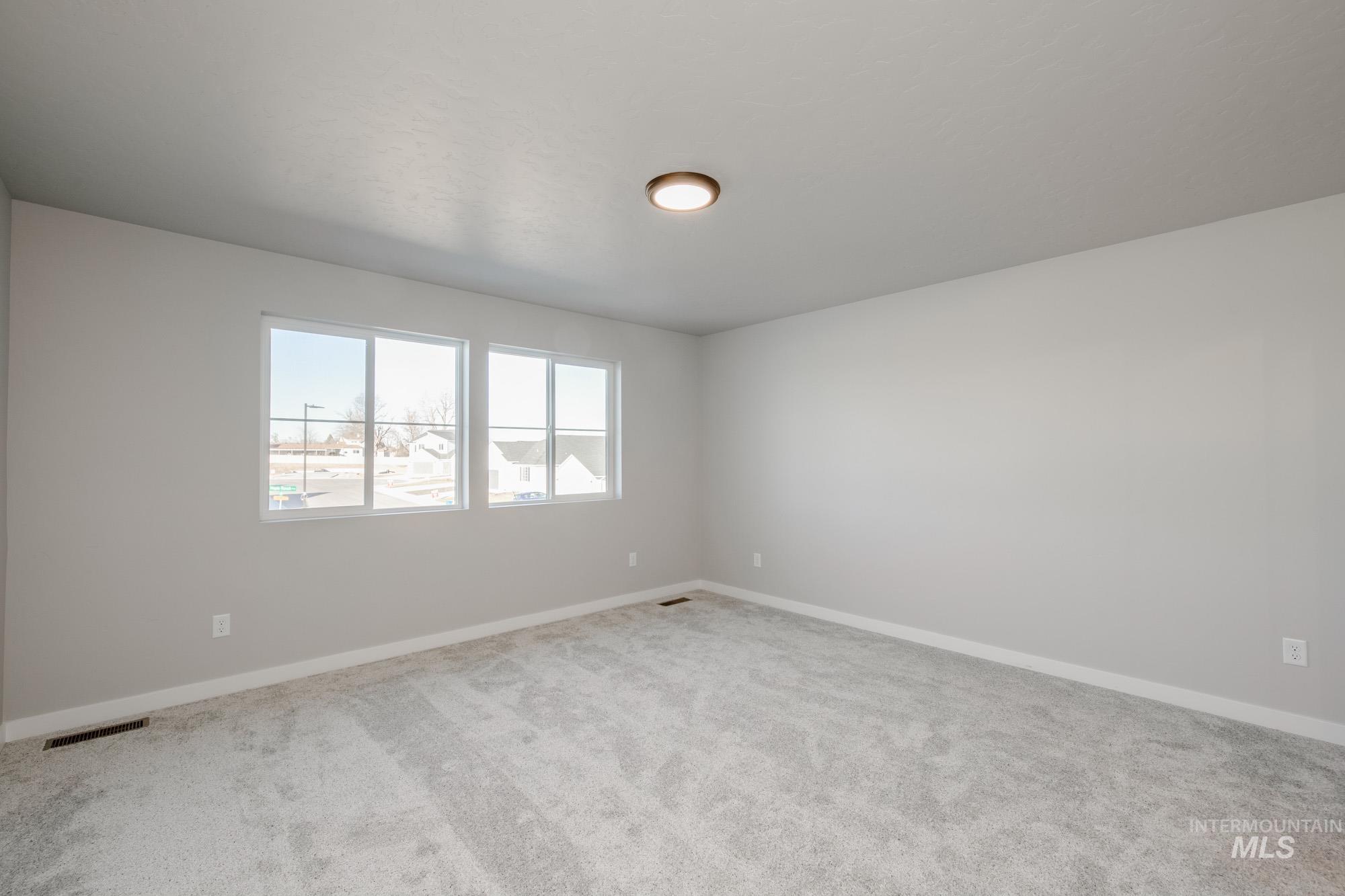 3210 South Maple Rnch Way Nampa, ID 83686 - Photo 13 of 22 Unfurnished room with baseboards and light carpet