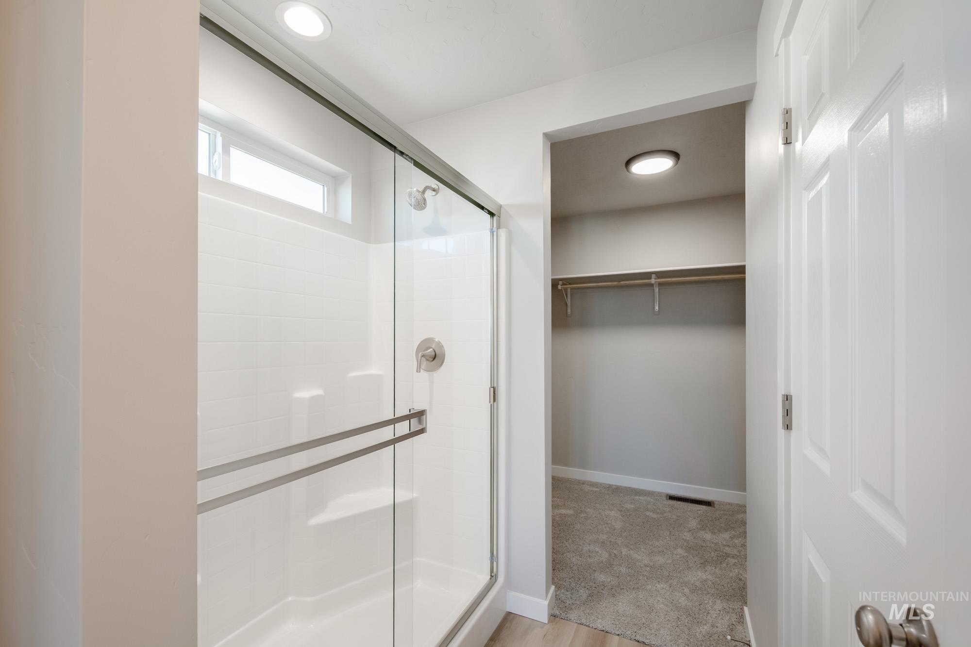 3210 South Maple Rnch Way Nampa, ID 83686 - Photo 15 of 22 Bathroom with a spacious closet, a shower stall, and light colored carpet