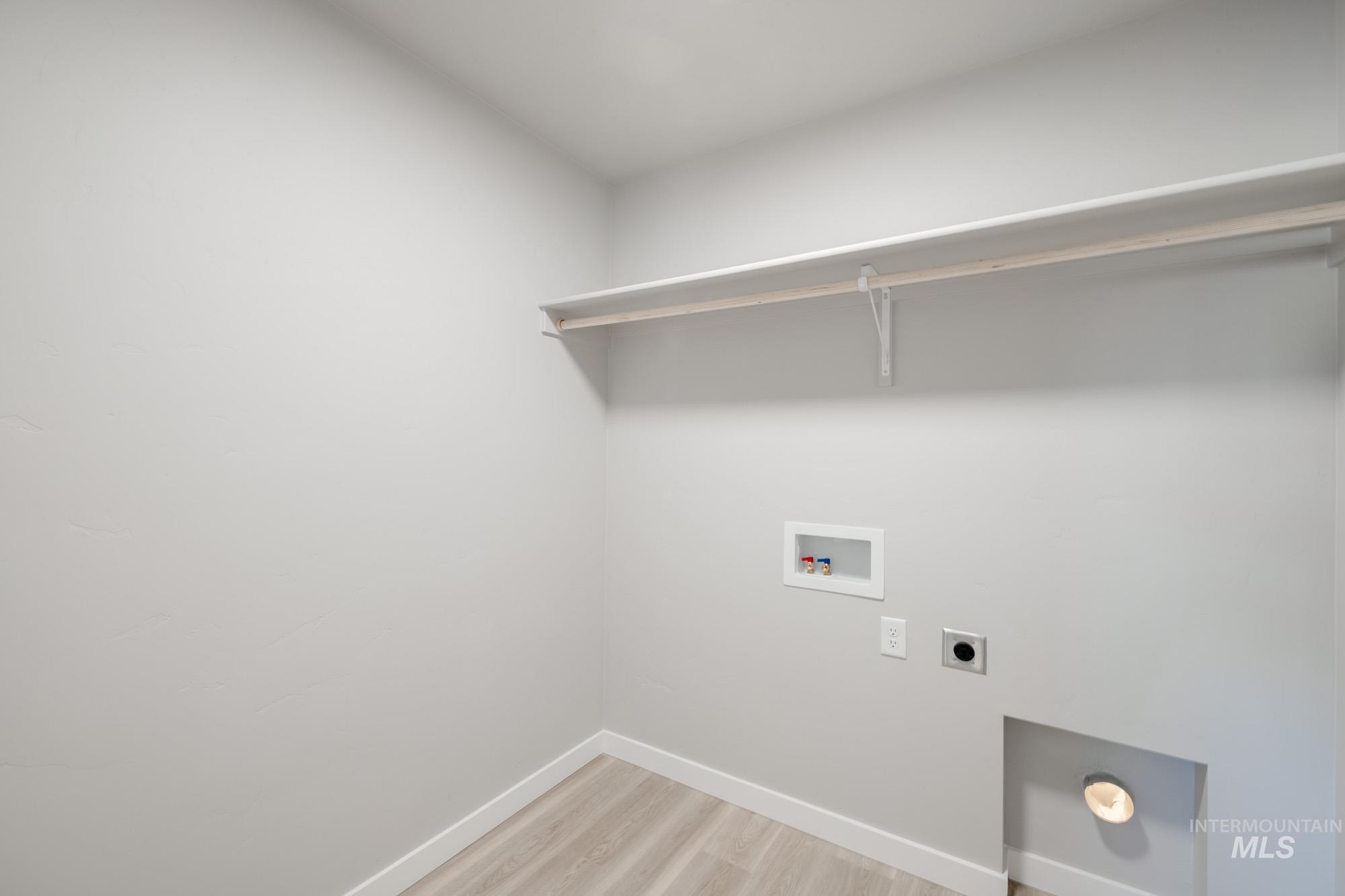 3210 South Maple Rnch Way Nampa, ID 83686 - Photo 17 of 22 Laundry area featuring light wood-style flooring, electric dryer hookup, and hookup for a washing machine