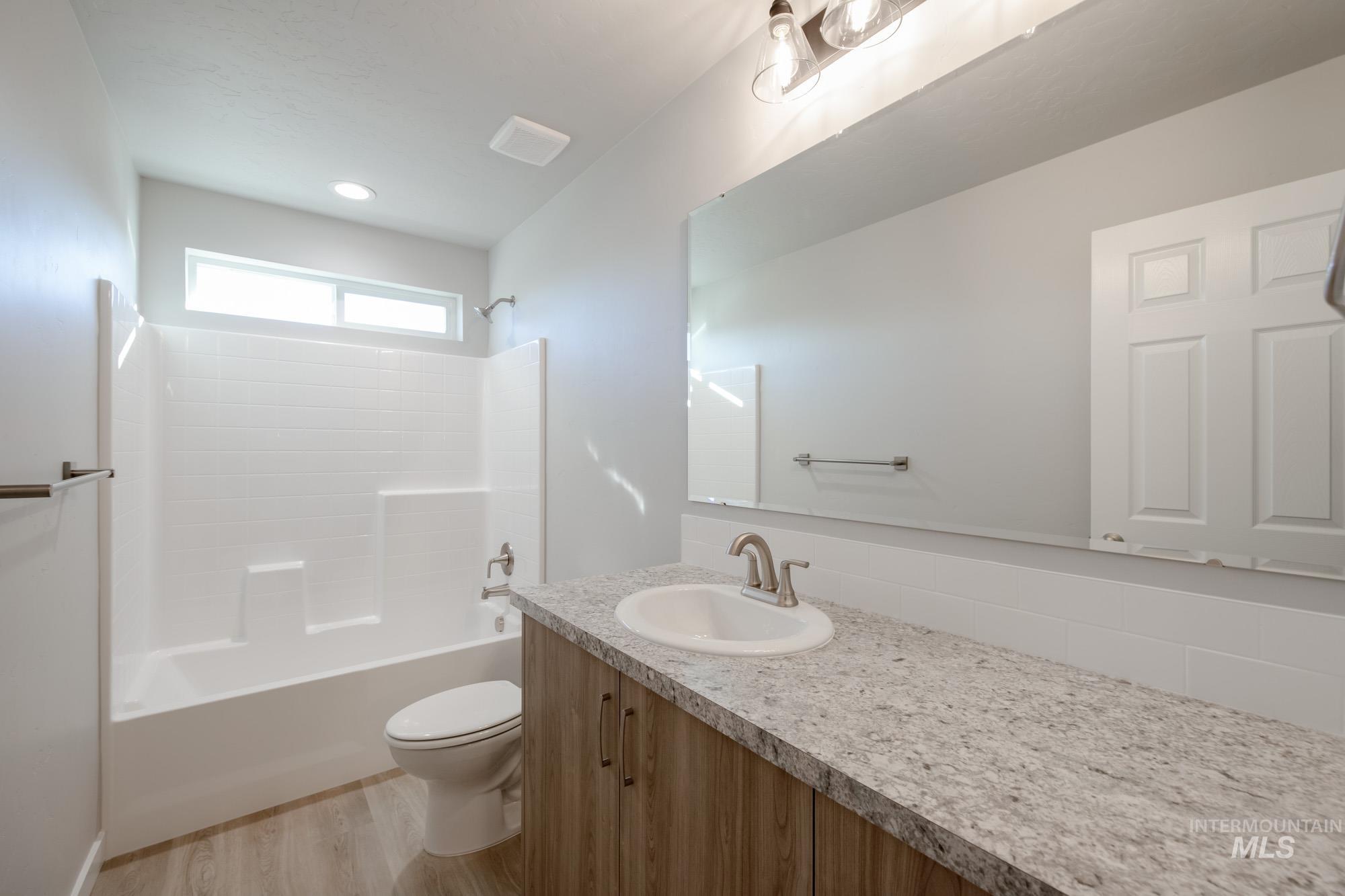 3210 South Maple Rnch Way Nampa, ID 83686 - Photo 18 of 22 Full bathroom with bathing tub / shower combination, vanity, and light wood-style floors
