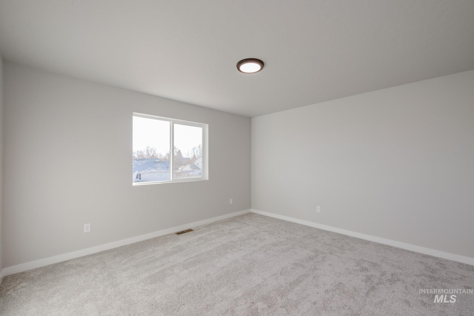 3210 South Maple Rnch Way Nampa, ID 83686 - Photo 19 of 22 Empty room featuring baseboards and carpet